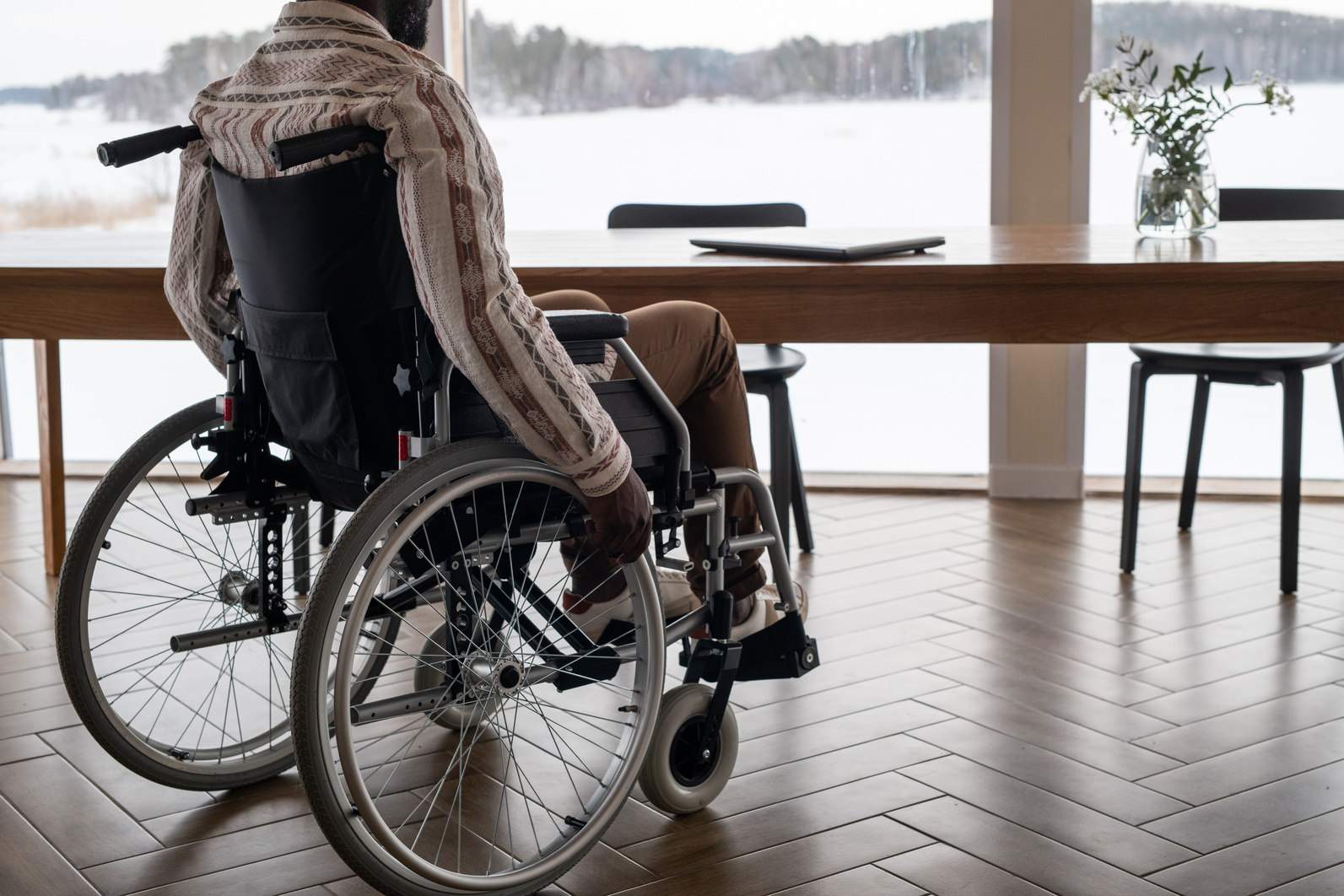 Young Contemporary Businessman with Paralysis Moving towards Table